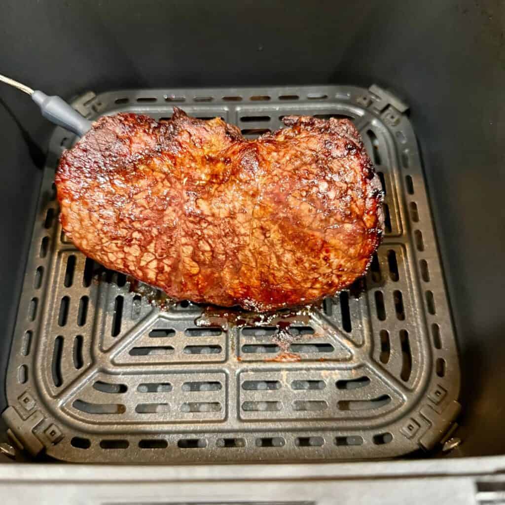 Cooked steak resting in the basket of a Tastee air fryer — an easy, no-fuss method perfect for Jack’s plain steak bites.