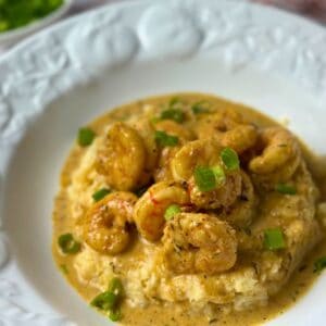Keto Cajun Shrimp and Cheesy Grits served over creamy cauliflower grits with a rich Creole-inspired sauce.